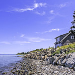 Blue sky at high tide on the bay and our Cape Cod Cottage.