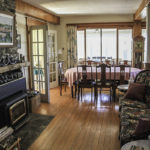 Another look at the living and dining area. Note the fireplace and wood-stove insert.